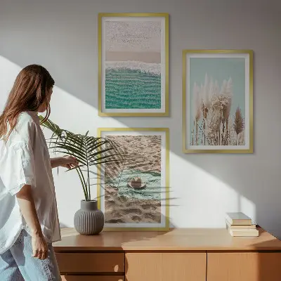 Set of 3 framed wall art pieces featuring a beach with waves, grass, and a hat