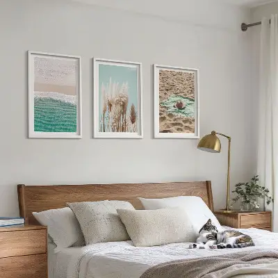 Set of 3 framed wall art pieces featuring a beach with waves, grass, and a hat