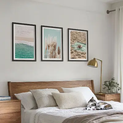 Set of 3 framed wall art pieces featuring a beach with waves, grass, and a hat