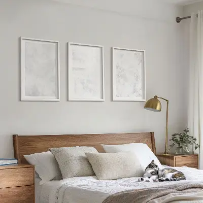 Set of 3 framed wall art pieces with white spots on a minimalist background