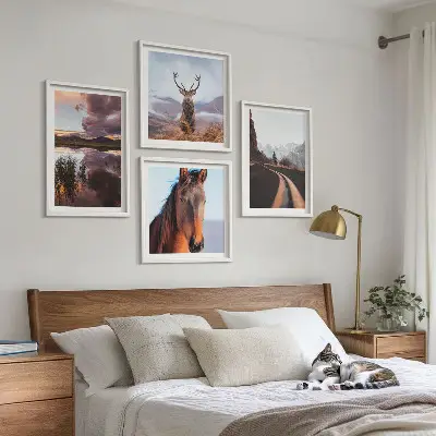 Set of 4 wall art pieces featuring mountain landscapes with reindeer and horse road scenes
