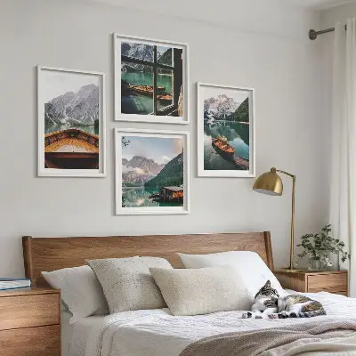 Set of 4 wall art pieces featuring a lake with mountains, boats, and a cottage window view