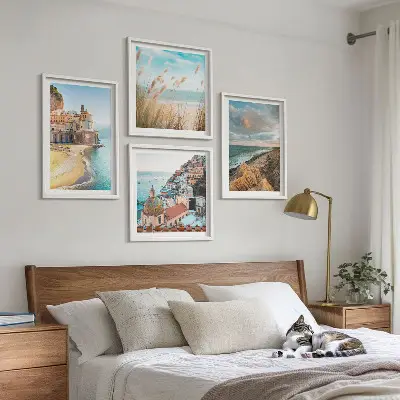 Set of 4 landscape wall art pieces featuring beach, city, and cliff scenes