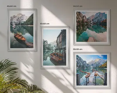 Wall art set featuring a lake with mountains, boats, and a cottage