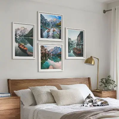 Wall art set featuring a lake with mountains, boats, and a cottage