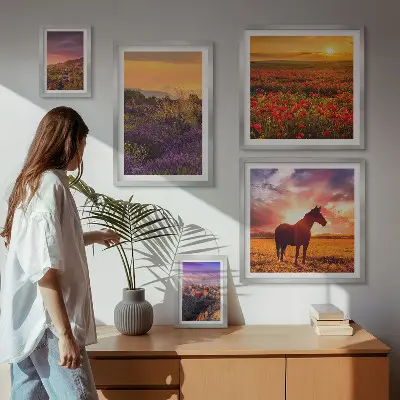 Gallery wall featuring landscape scenes of nature, horses, and flowers
