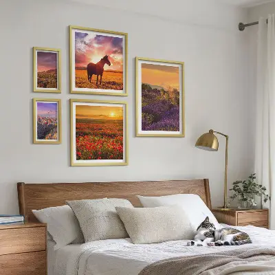 Gallery wall featuring landscape scenes of nature, horses, and flowers