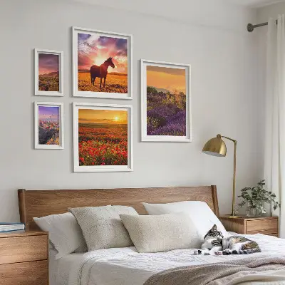 Gallery wall featuring landscape scenes of nature, horses, and flowers