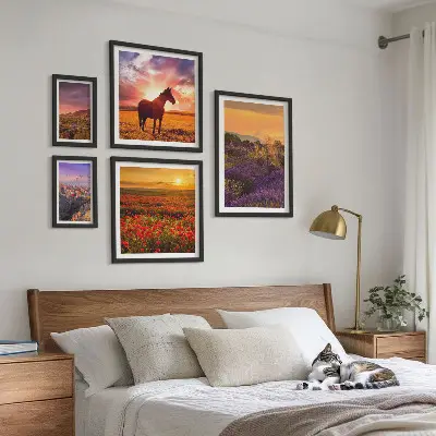 Gallery wall featuring landscape scenes of nature, horses, and flowers