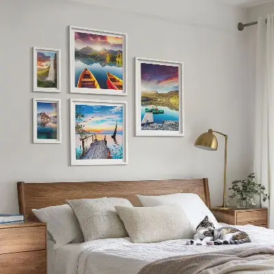 Gallery wall featuring landscape scenes of waterfalls and lakes
